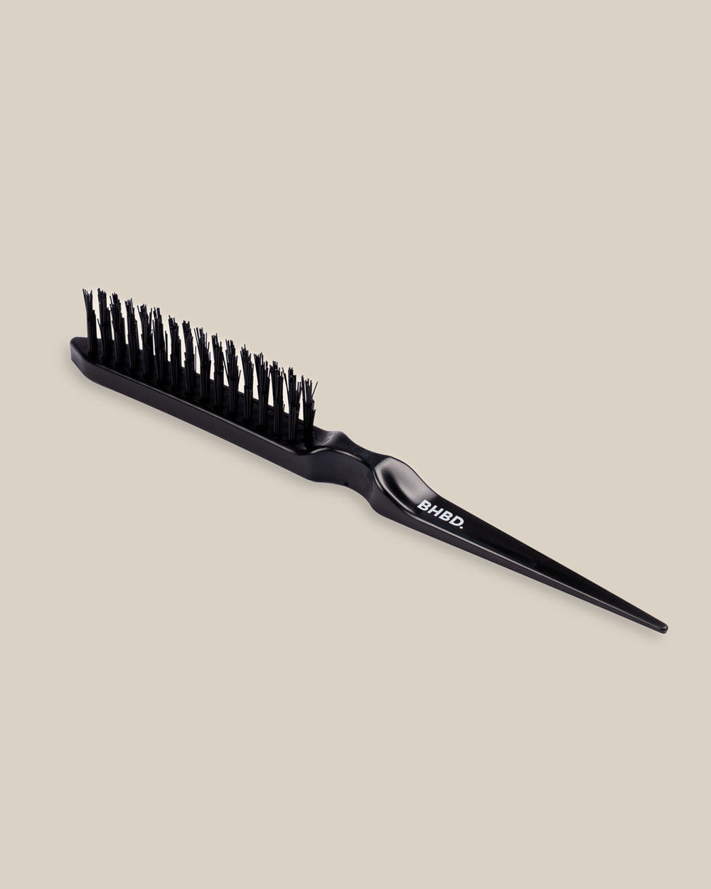 BHBD Remover Brush - Black hairbrush on a beige background - White BHBD Logo