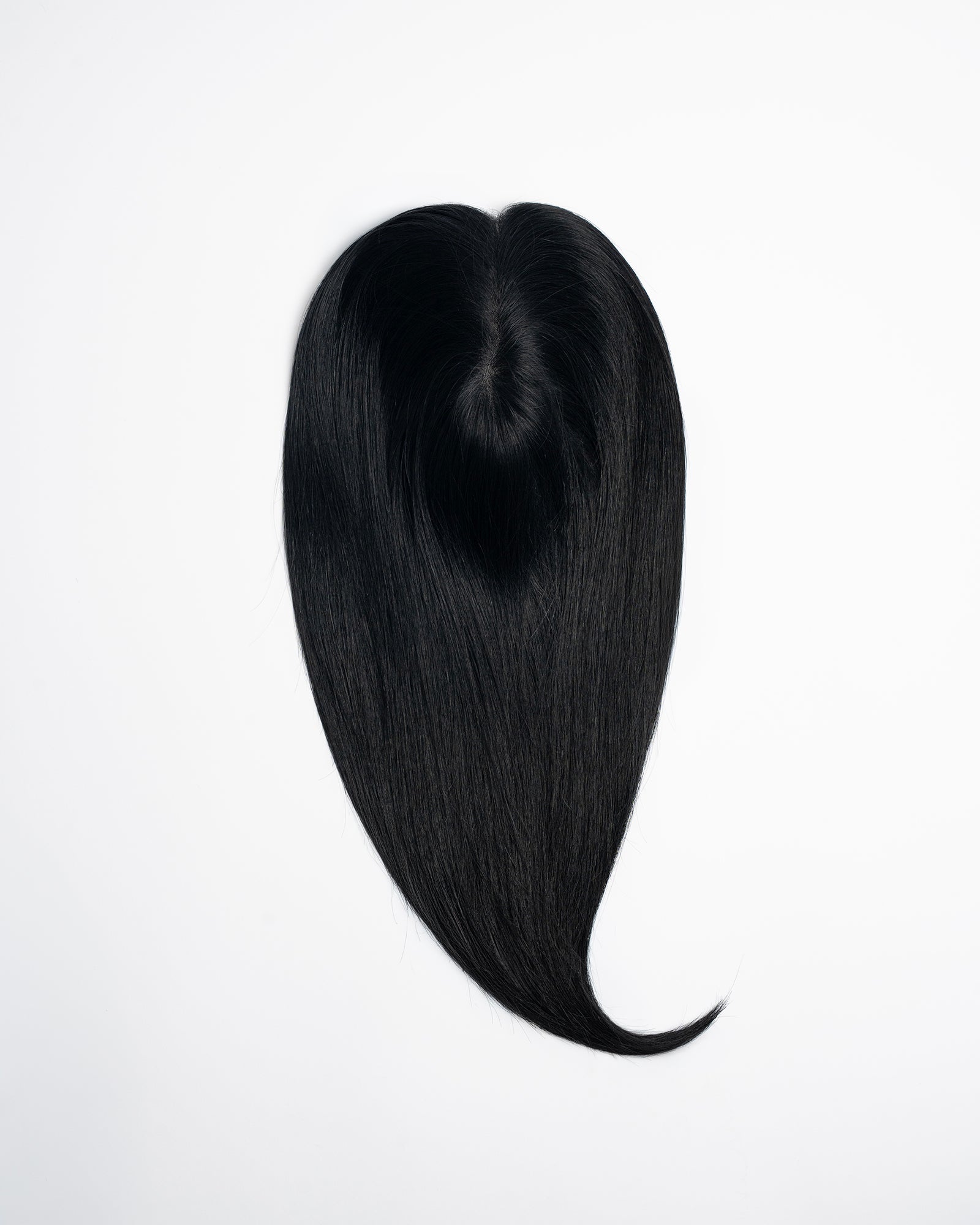 Signature Base hair topper in natural black (1N) with smooth, even tone and high shine on a white background.