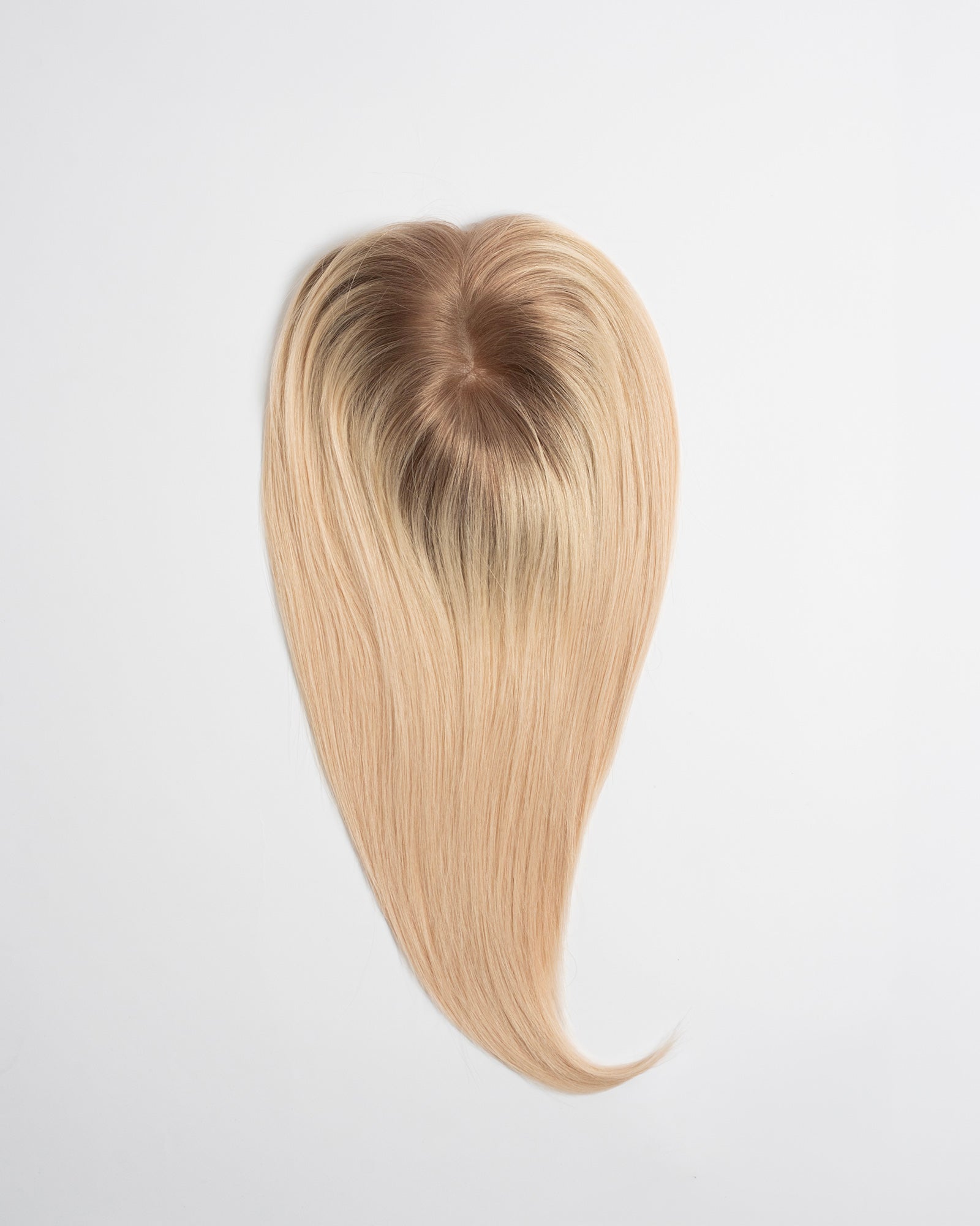 Hair topper Signature Base in rooted blond shade with darker roots and light blond lengths for a natural blend on a white background.