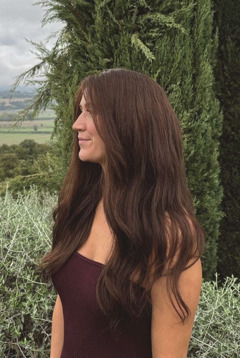 Valentina Wig – 40cm dark brown lace wig worn outdoors on woman; natural Remy hair styled with soft, glossy waves.