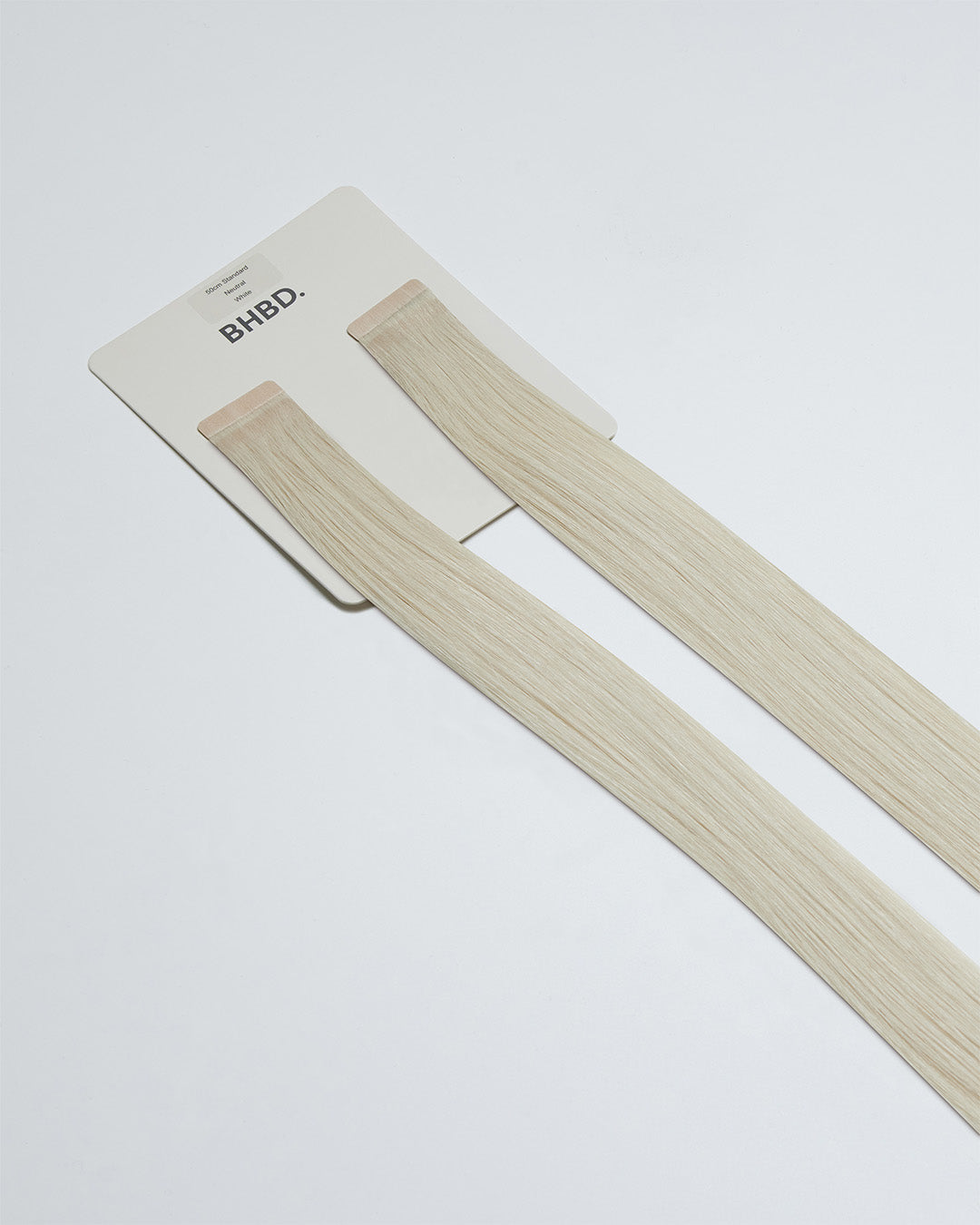 Tape Extensions White – pre-taped Remy human hair extensions in pure white shade; seamless, soft and tangle-free; comes in 35cm, 50cm, and 60cm. 100% Remy hair, gentle extensions.