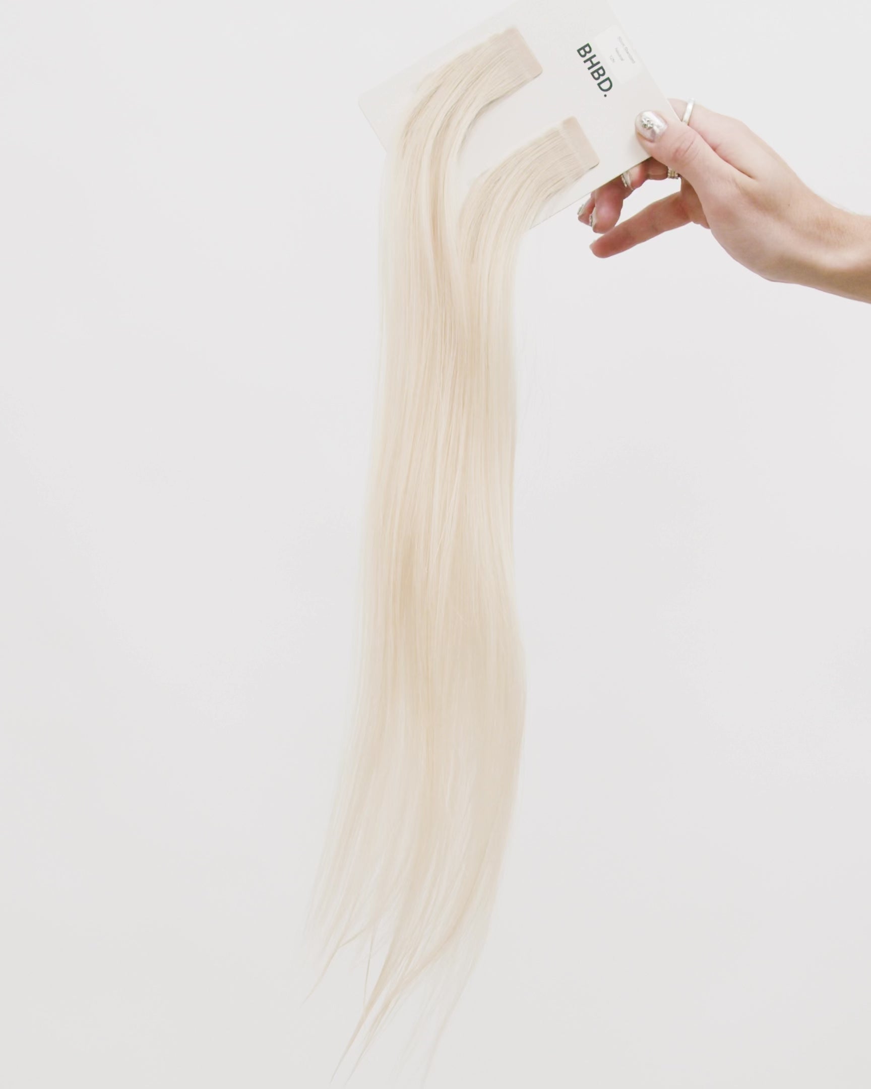 Tape Extensions 12N – pre-taped Remy human hair extensions in light natural blonde shade; seamless, soft and tangle-free; comes in 35cm, 50cm, and 60cm. 100% Remy hair, gentle extensions.