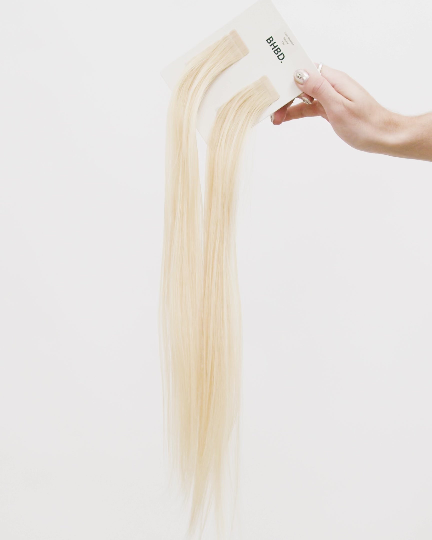 Tape Extensions 11N – pre-taped Remy human hair extensions in light natural blonde shade; seamless, soft and tangle-free; comes in 35cm, 50cm, and 60cm. 100% Remy hair, gentle extensions.