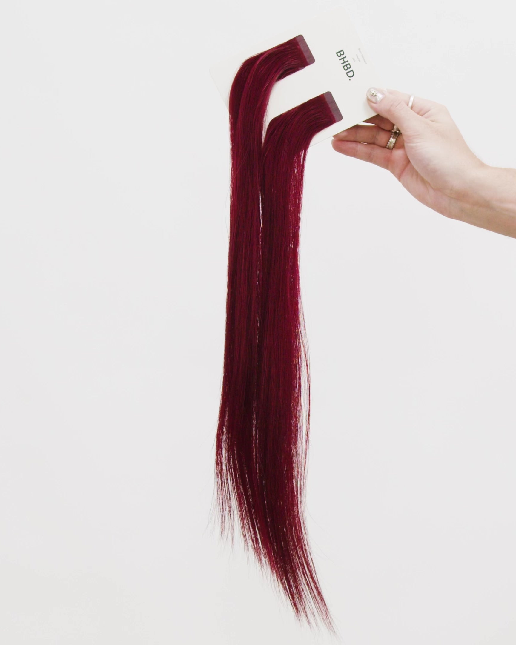 Tape Extensions 6RV – pre-taped Remy human hair extensions in deep red-violet shade; seamless, soft and tangle-free; comes in 35cm, 50cm, and 60cm. 100% Remy hair, gentle extensions.