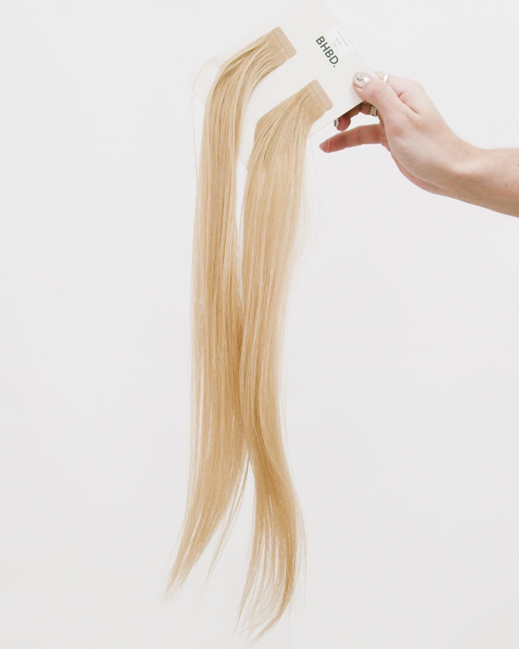 Tape Extensions 10NB – pre-taped Remy human hair extensions in light natural beige blonde shade; seamless, soft and tangle-free; comes in 35cm, 50cm, and 60cm. 100% Remy hair, gentle extensions.