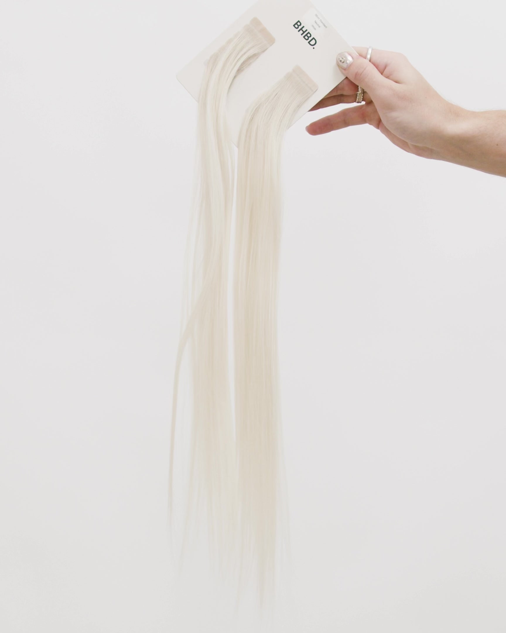 Tape Extensions White – pre-taped Remy human hair extensions in pure white shade; seamless, soft and tangle-free; comes in 35cm, 50cm, and 60cm. 100% Remy hair, gentle extensions.