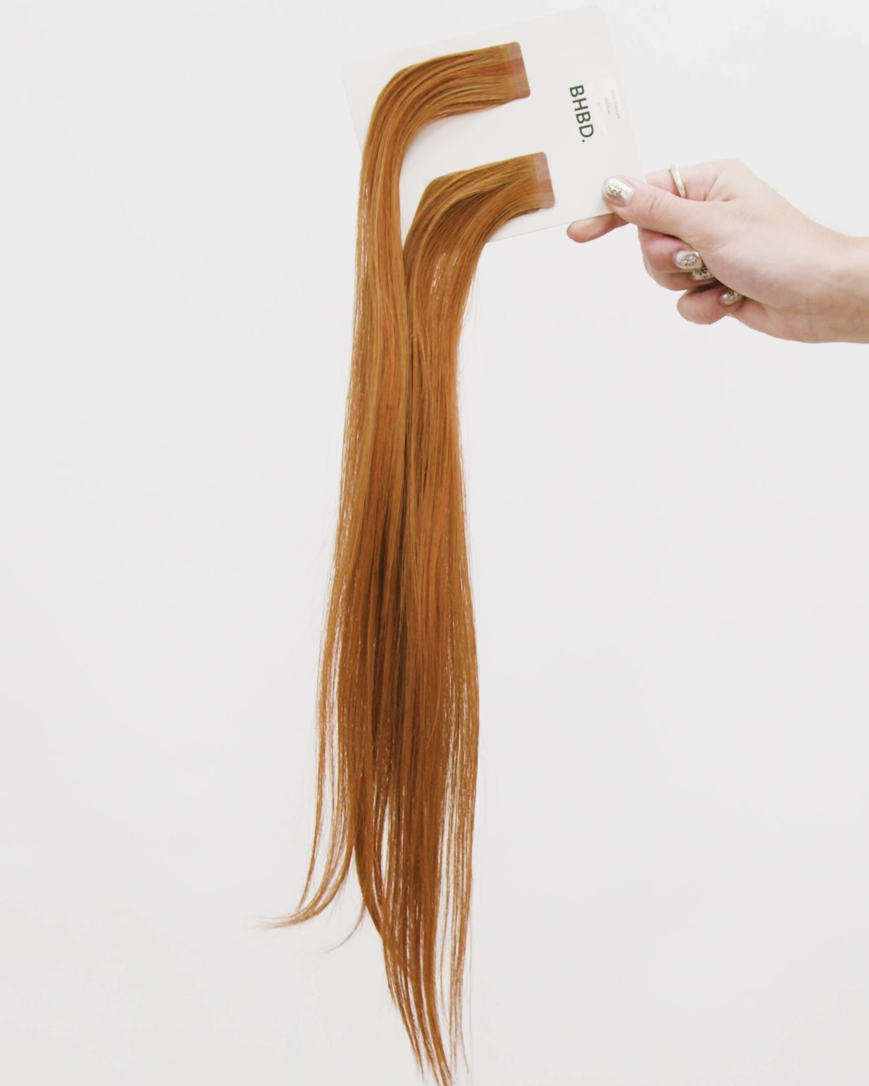 Tape Extensions 8CG – pre-taped Remy human hair extensions in copper golden blonde shade; seamless, soft and tangle-free; comes in 35cm, 50cm, and 60cm. 100% Remy hair, gentle extensions.