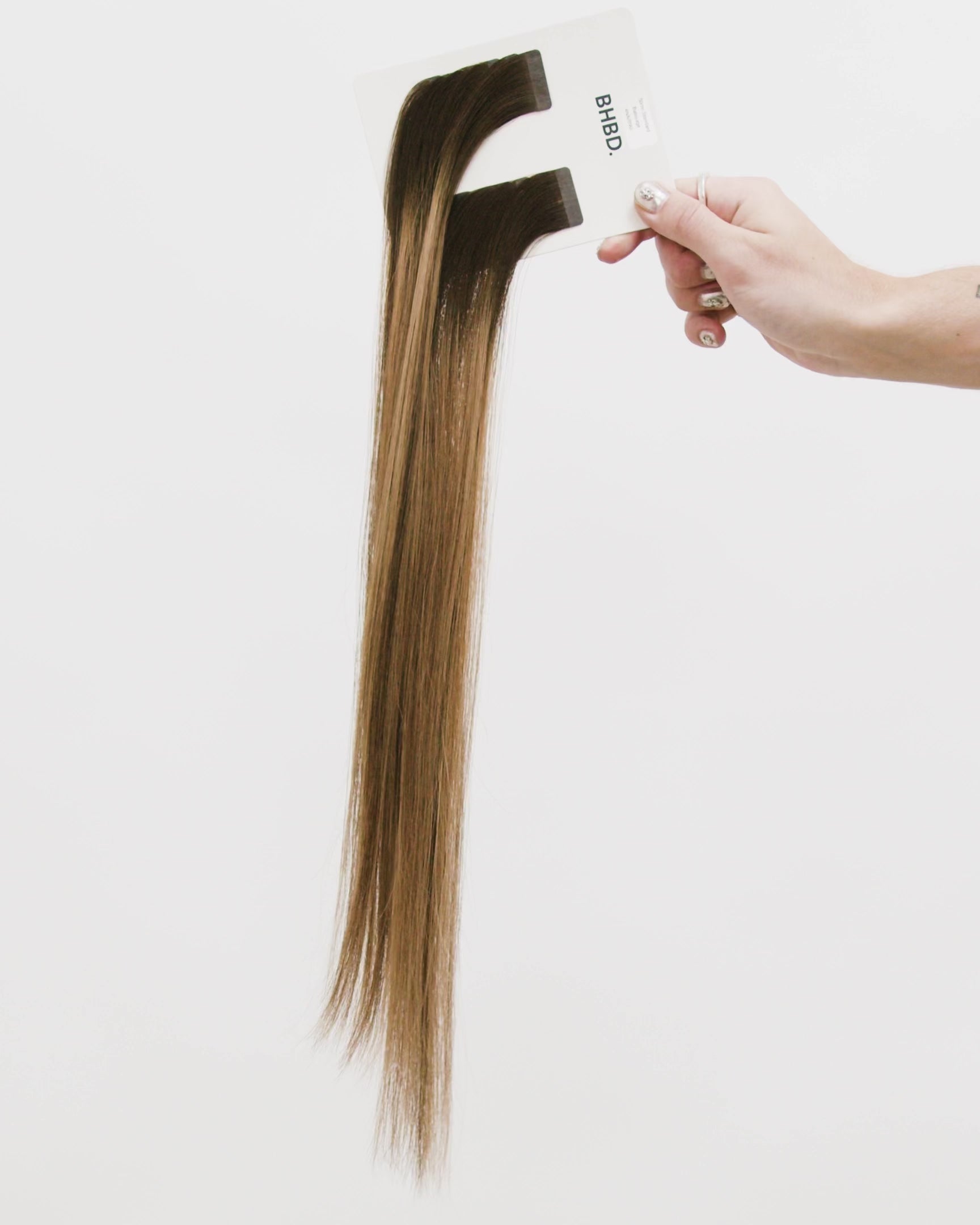 Tape Extensions 4NA/8NG – pre-taped Remy human hair extensions in natural ash brown blended with golden blonde; seamless, soft and tangle-free; comes in 35cm, 50cm, and 60cm. 100% Remy hair, gentle extensions.
