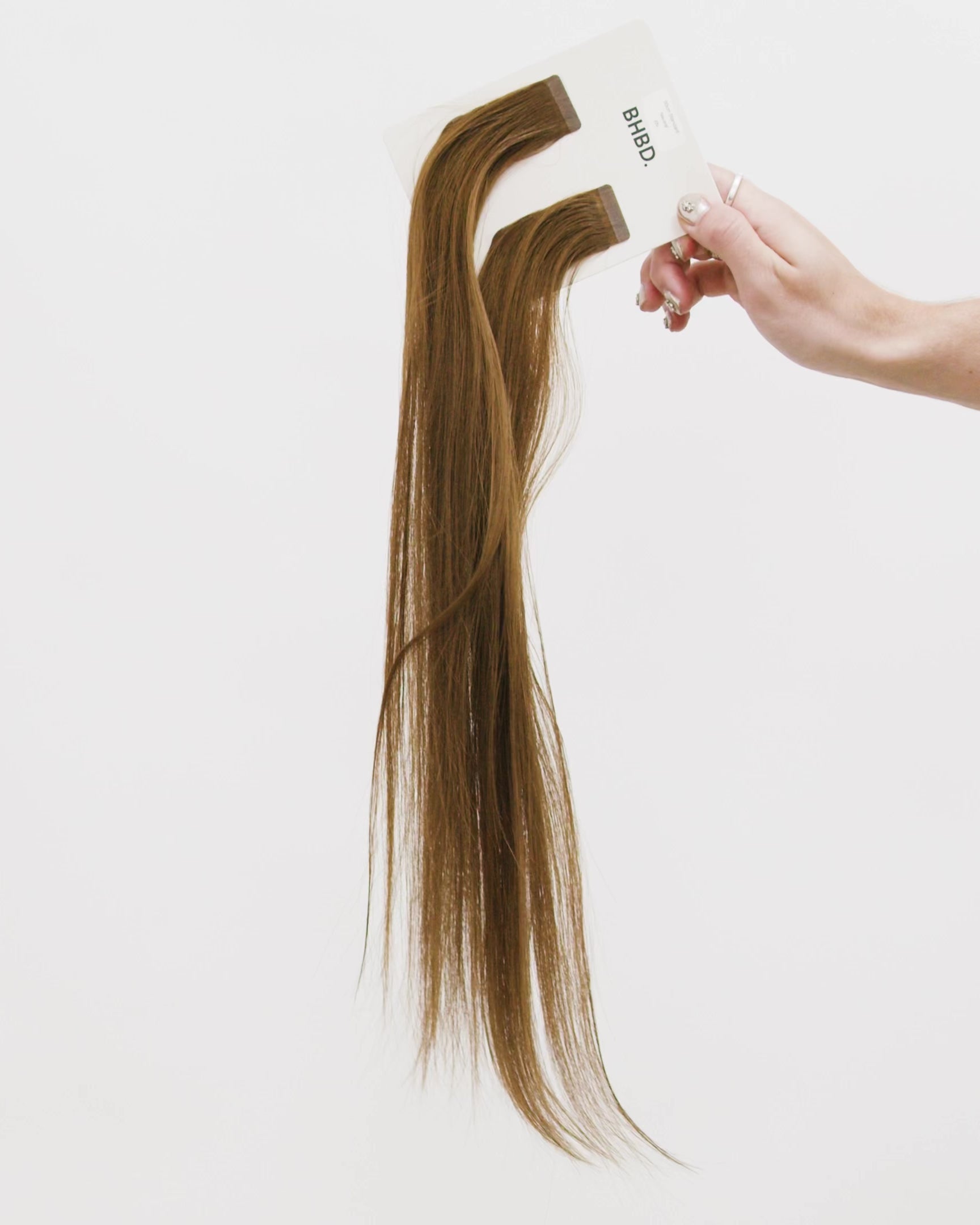 Tape Extensions 6N – pre-taped Remy human hair extensions in medium natural brown shade; seamless, soft and tangle-free; comes in 35cm, 50cm, and 60cm. 100% Remy hair, gentle extensions.