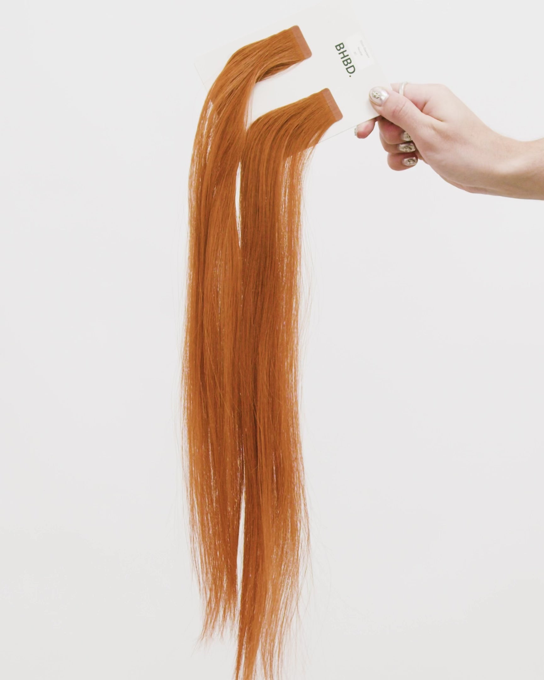 Tape Extensions 8C – pre-taped Remy human hair extensions in warm copper medium blonde shade; seamless, soft and tangle-free; comes in 35cm, 50cm, and 60cm. 100% Remy hair, gentle extensions.
