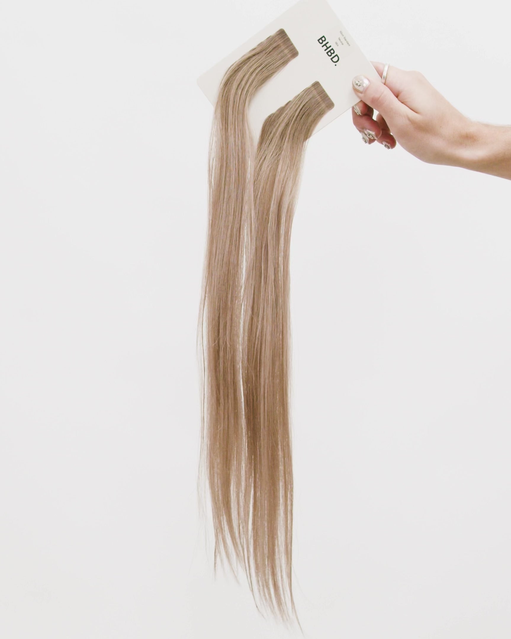 Tape Extensions 9BA – pre-taped Remy human hair extensions in light ash blonde shade; seamless, soft and tangle-free; comes in 35cm, 50cm, and 60cm. 100% Remy hair, gentle extensions.