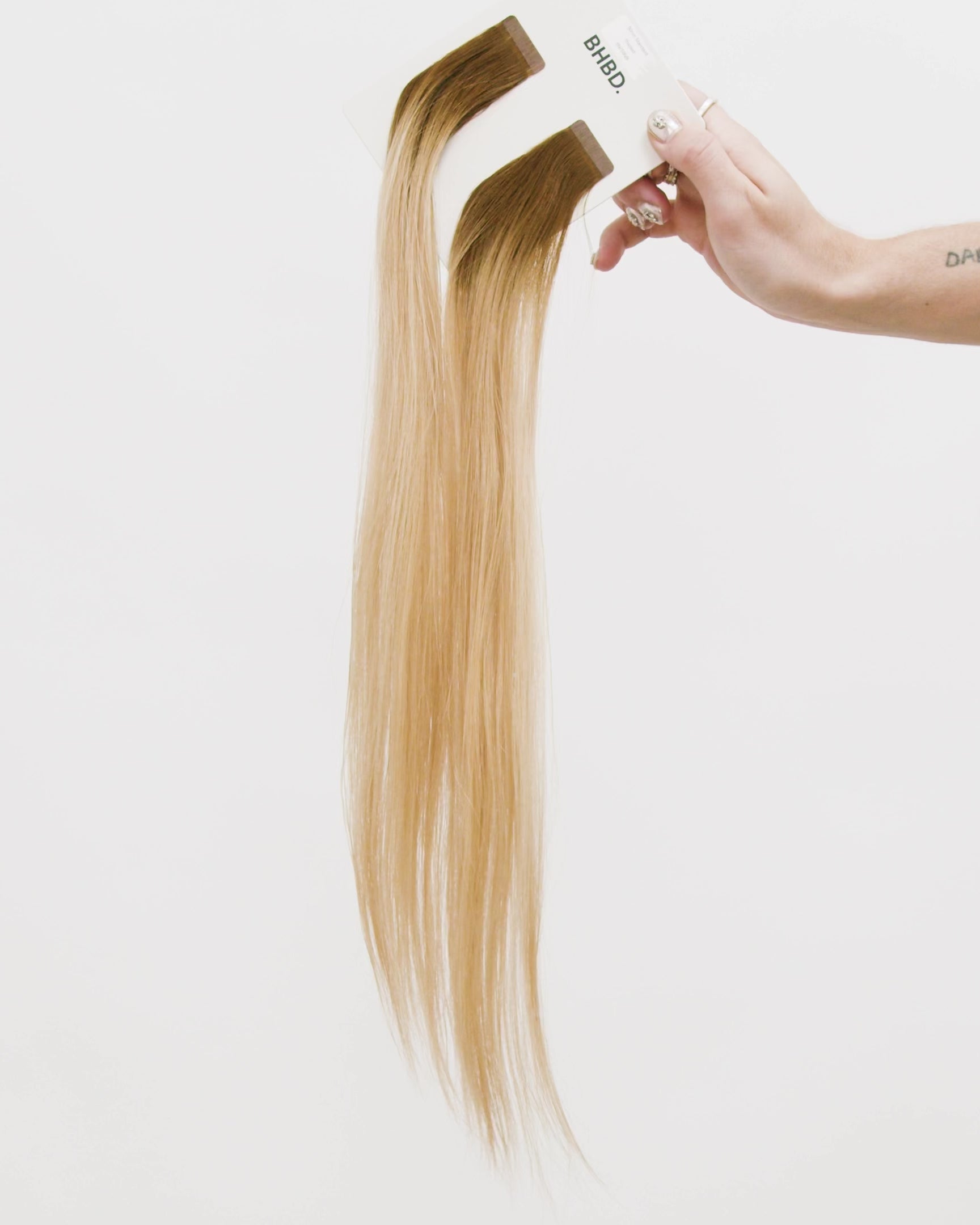 Tape Extensions 6N/10NB – pre-taped Remy human hair extensions in natural brown blended with light beige blonde; seamless, soft and tangle-free; comes in 35cm, 50cm, and 60cm. 100% Remy hair, gentle extensions.