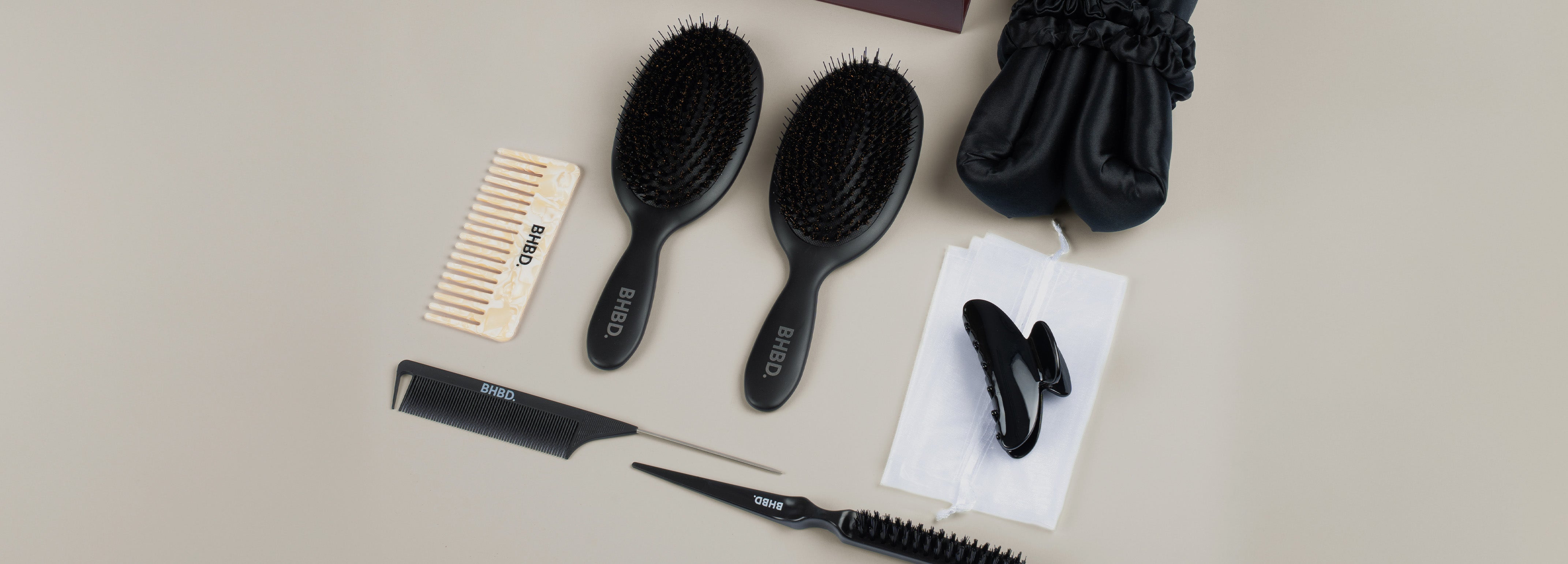 Close-up of BHBD round brushes styling sleek blonde hair, showcasing the smooth, professional finish achieved with ceramic and ionic technology.