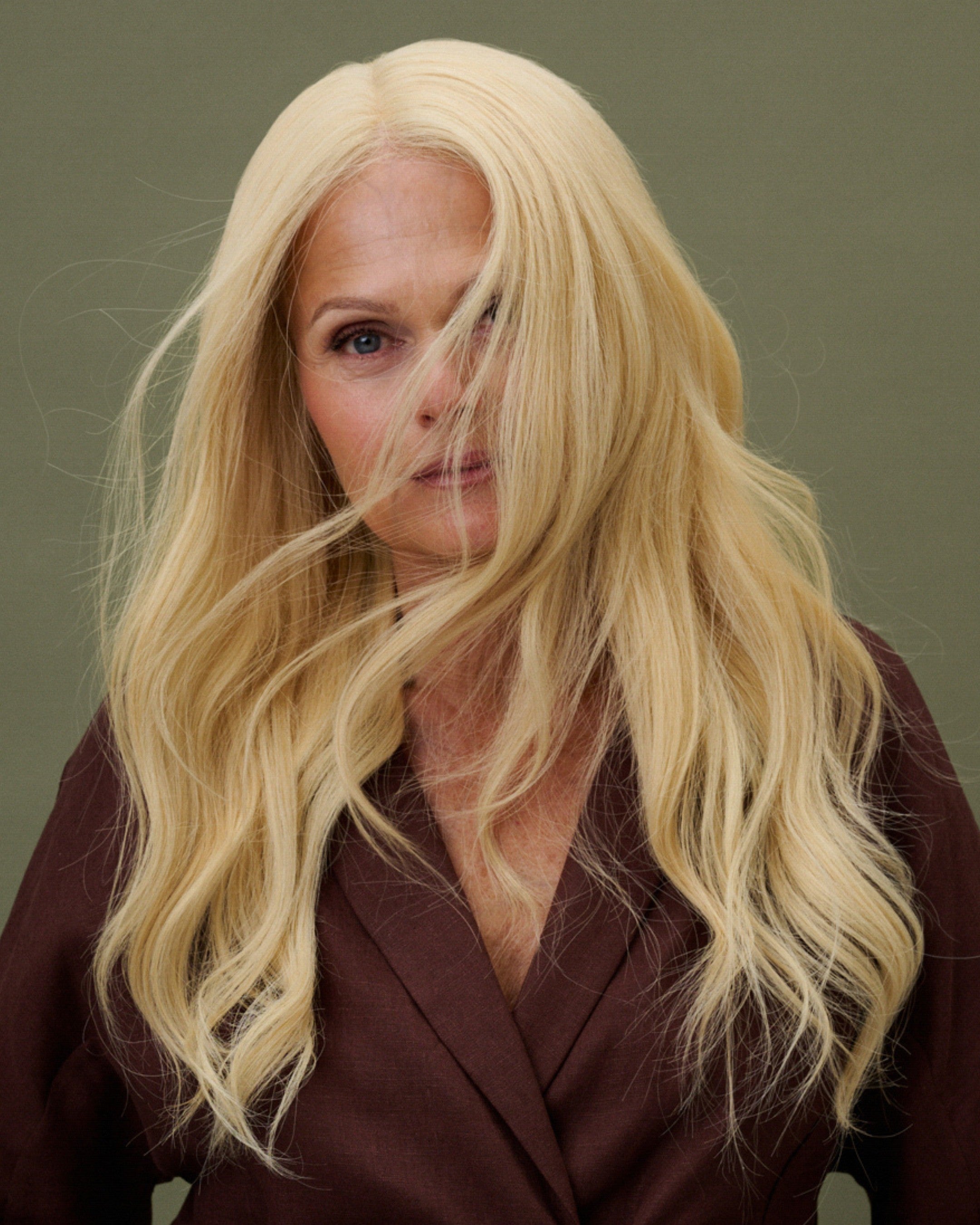 Model front view wearing Livia Wig – 40cm full lace wig in light warm blonde; 100% Remy hair with HD lace and pre-plucked hairline; styled with natural layers.