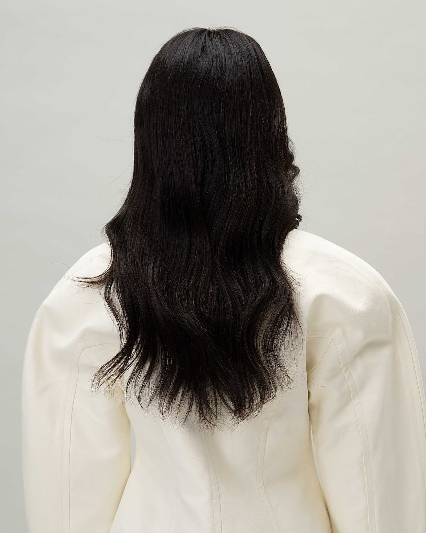 Back view on model with Aurora Wig – 40cm black Remy hair lace wig, shown from the back with layered lengths and natural scalp effect.
