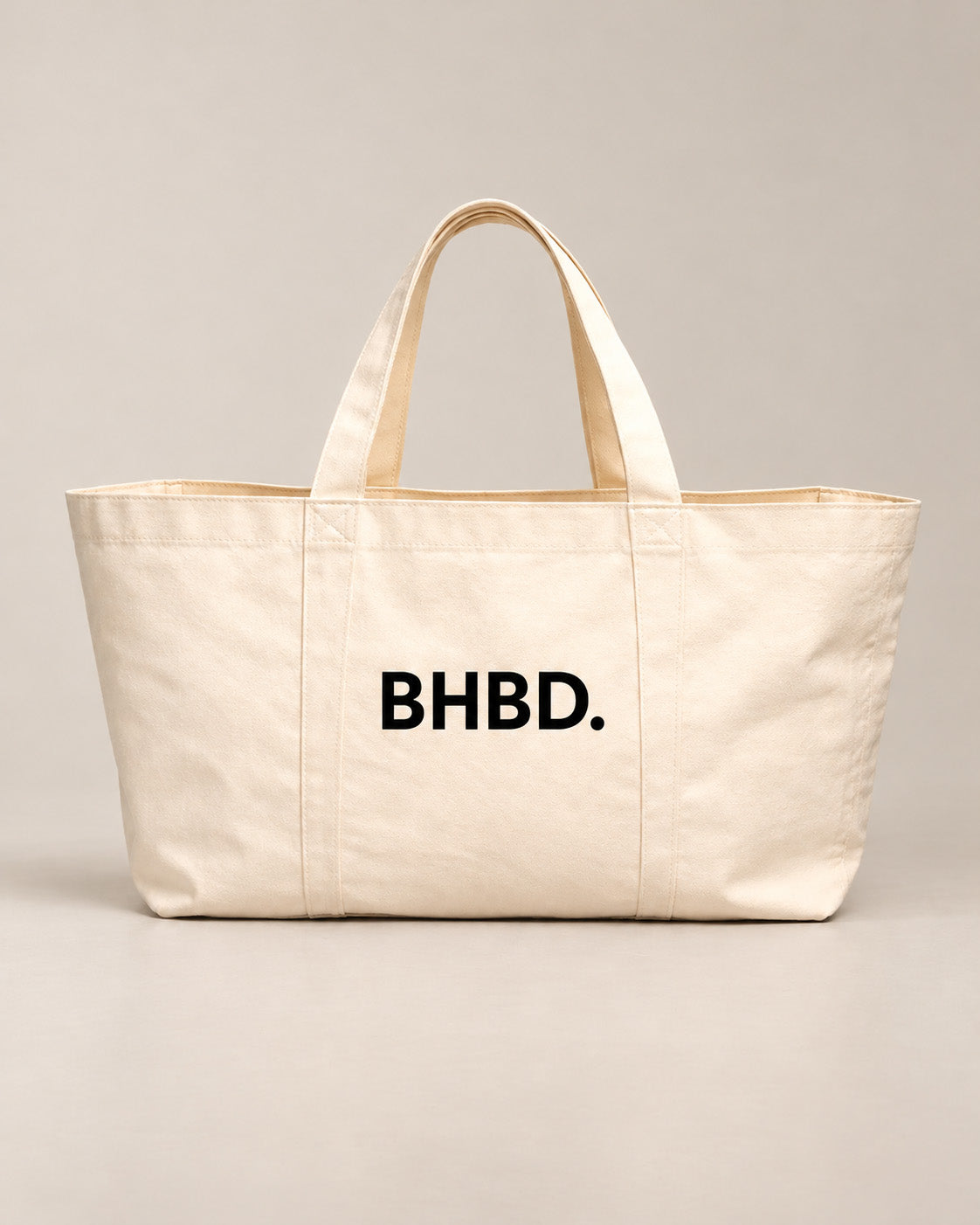 light beige totebag with BHBD logo on white background