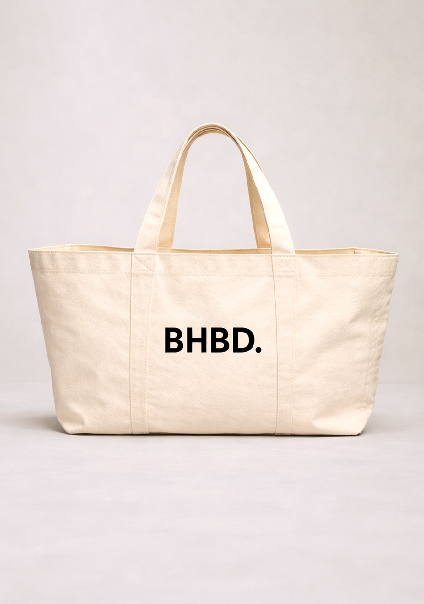 light beige totebag with BHBD logo on white background