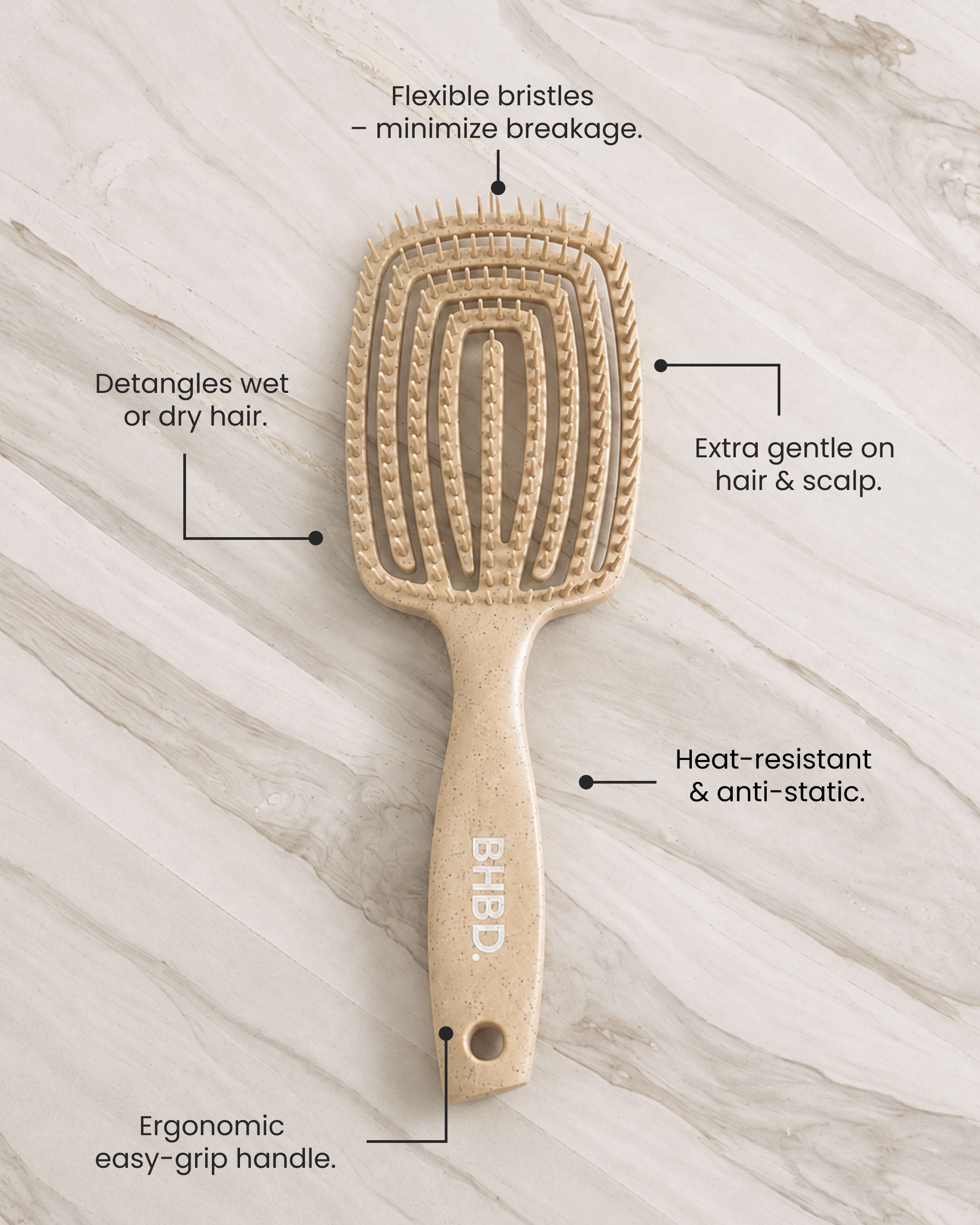 Wet detangler brush with flexible bristles that reduce breakage and gently detangle knots without pulling.