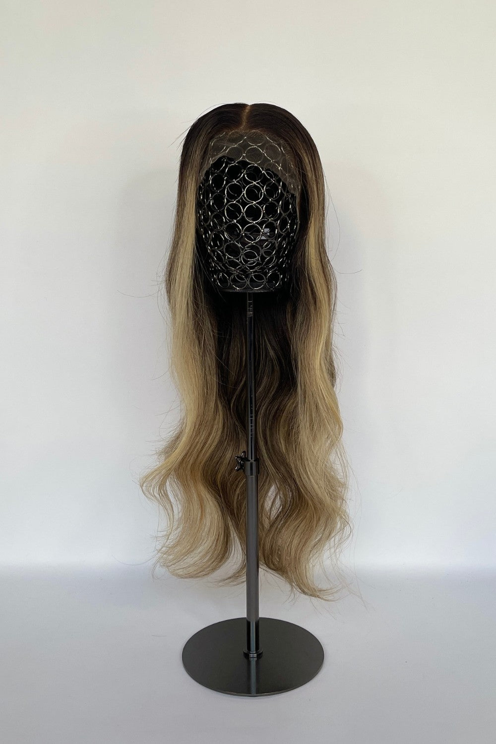 BHBD HD lace wig featuring an ombré effect with a dark root transitioning into soft blonde waves. Made with 100% real Remy hair, offering a natural parting and seamless, elegant finish.