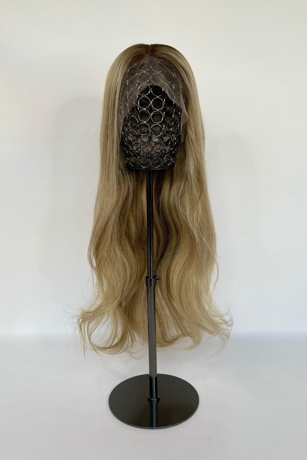 BHBD lace wig in a sandy blonde ombré shade with long, flowing waves. Made with 100% real Remy hair, offering a natural parting and seamless fit for versatile styling.