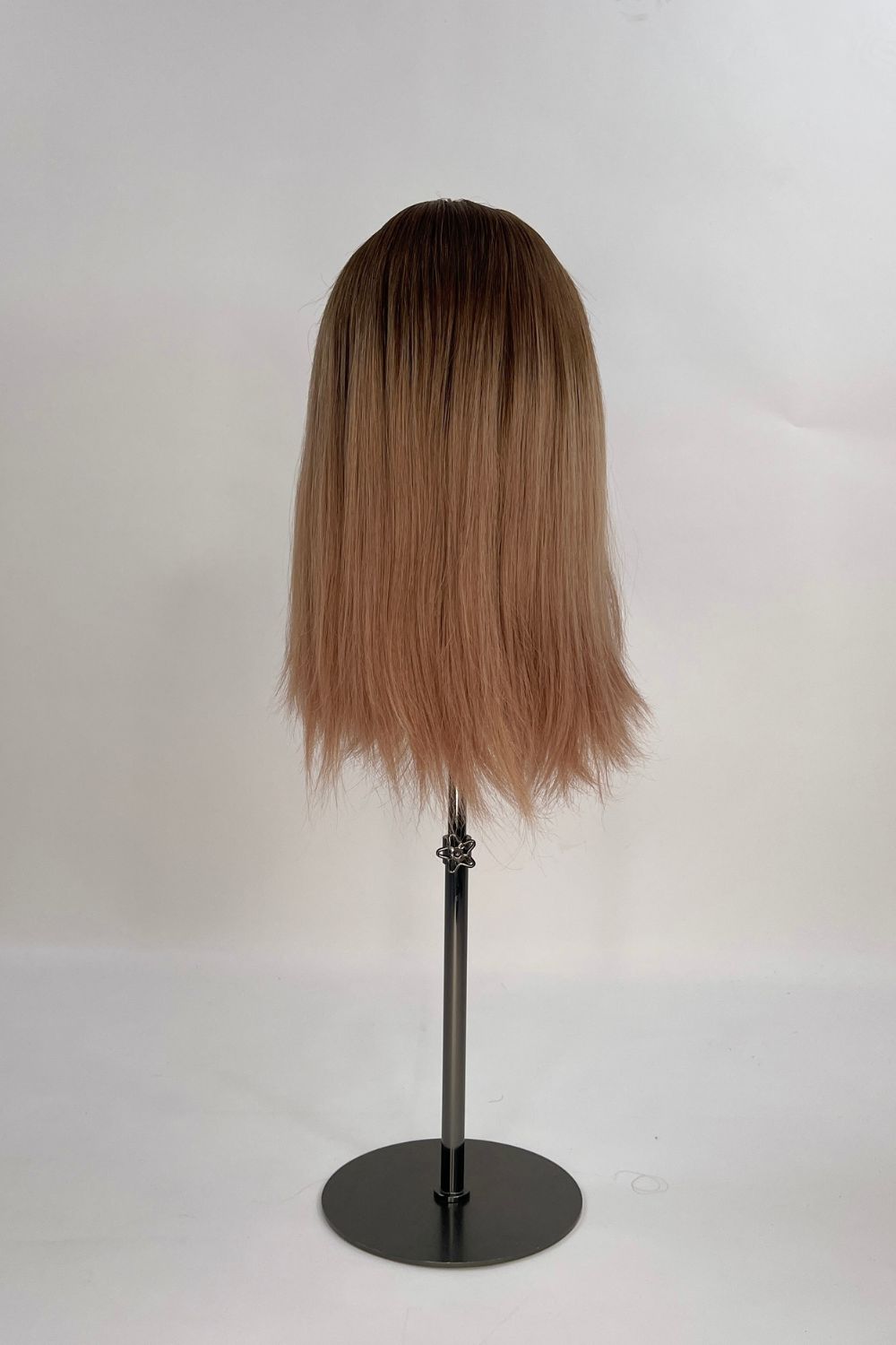 Sophia Wig – medium brown with subtle highlights, 30cm full-lace wig; 100% Remy hair with transparent Swiss lace; shown on wid stand from the back.