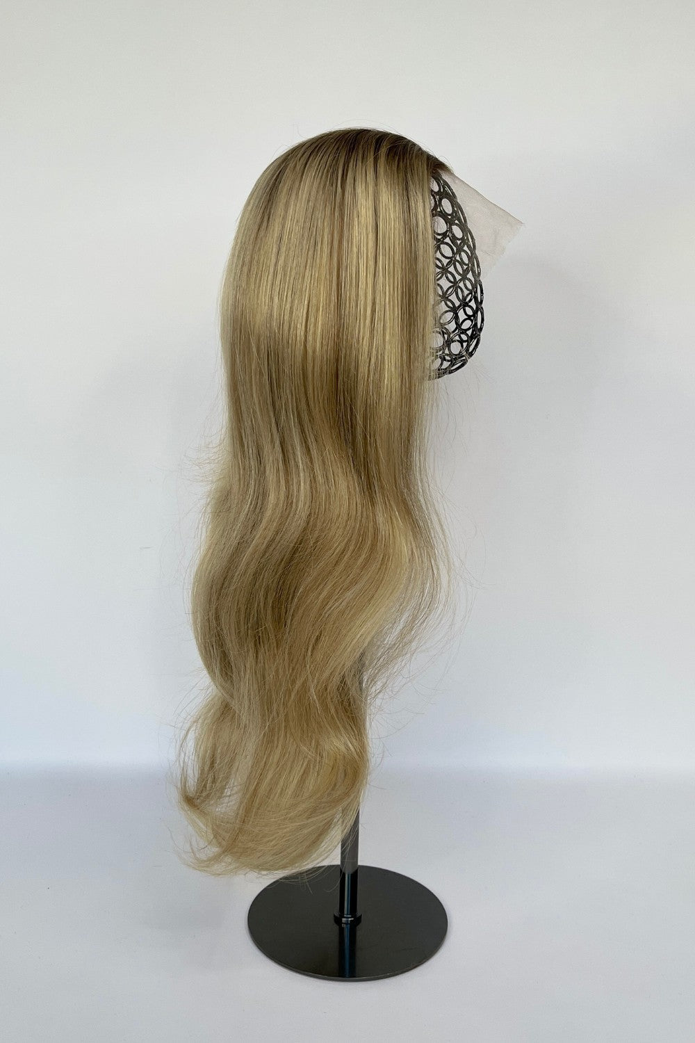 BHBD lace wig in a sandy blonde ombré shade with long, flowing waves. Made with 100% real Remy hair, offering a natural parting and seamless fit for versatile styling.