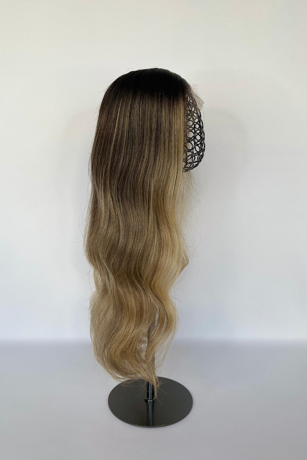 BHBD HD lace wig featuring an ombré effect with a dark root transitioning into soft blonde waves. Made with 100% real Remy hair, offering a natural parting and seamless, elegant finish.