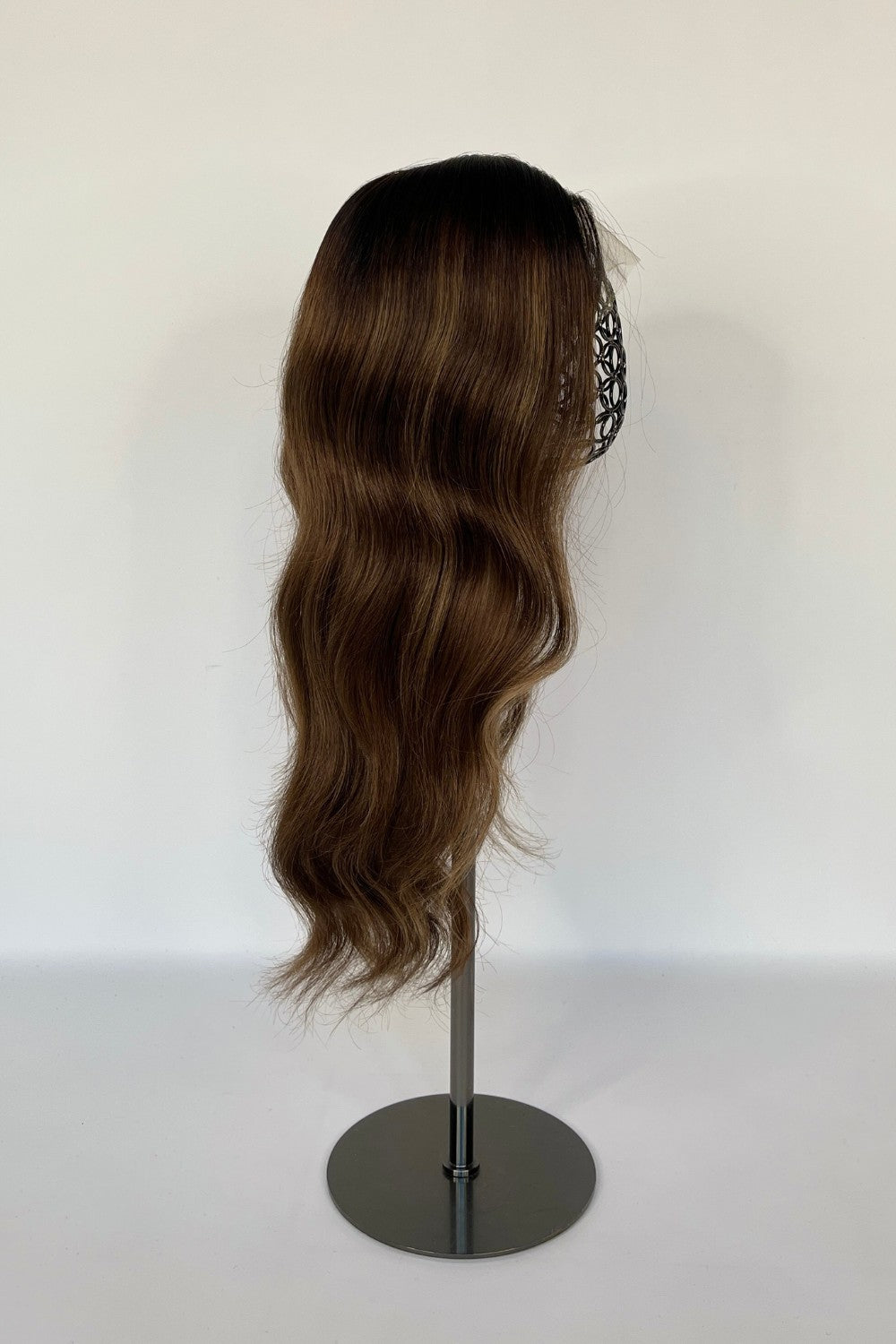 BHBD lace wig in a warm chestnut brown shade with soft, natural waves. Made with 100% real Remy hair, providing a seamless fit and natural parting for versatile styling options.