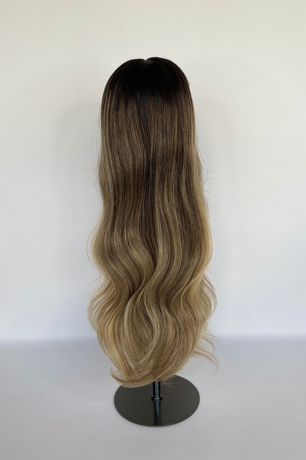 BHBD HD lace wig featuring an ombré effect with a dark root transitioning into soft blonde waves. Made with 100% real Remy hair, offering a natural parting and seamless, elegant finish.