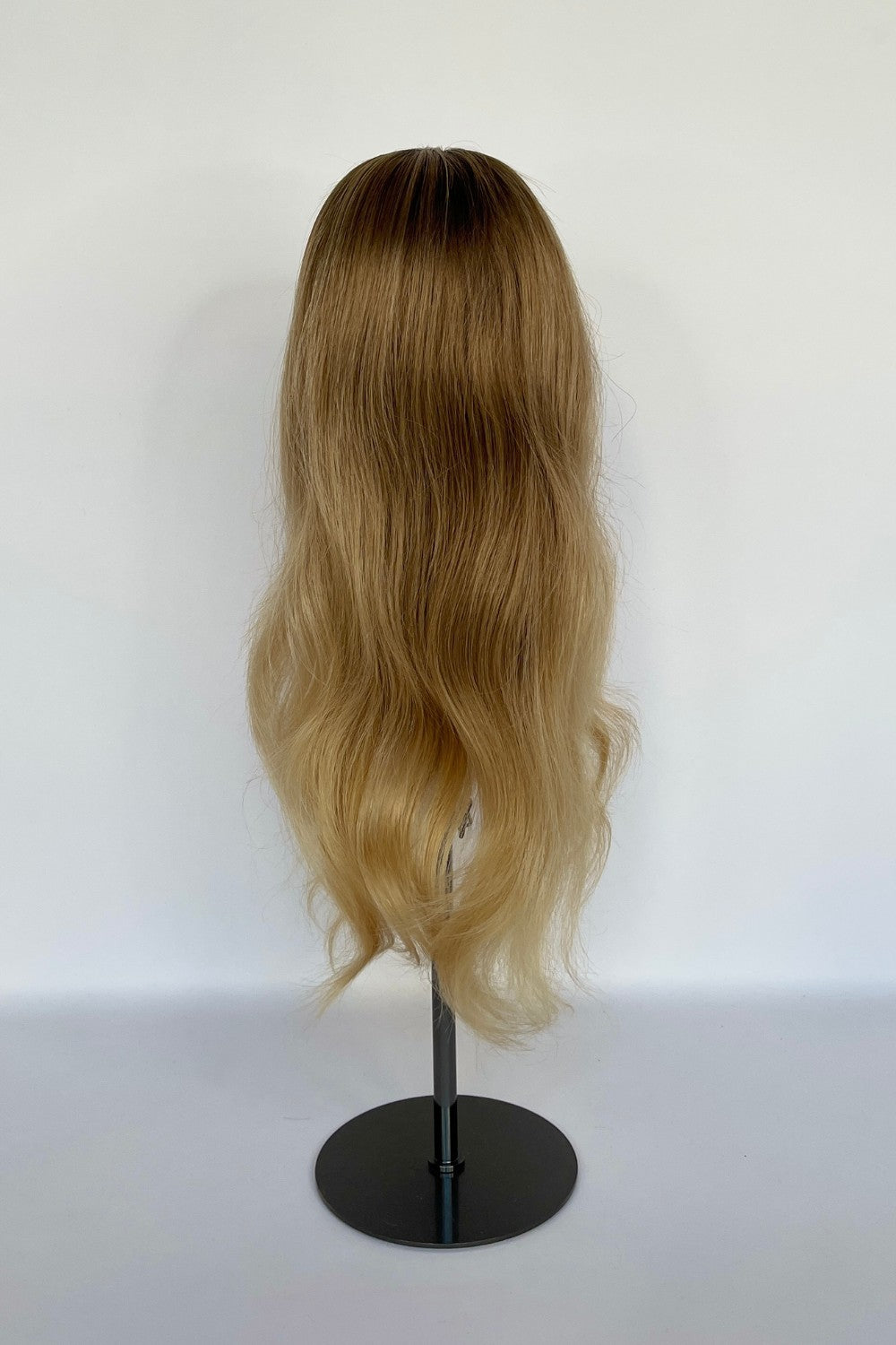 BHBD HD-lace wig in a honey blonde ombré shade with long, flowing waves. Made with 100% real Remy hair, providing a natural parting and seamless versatility for styling