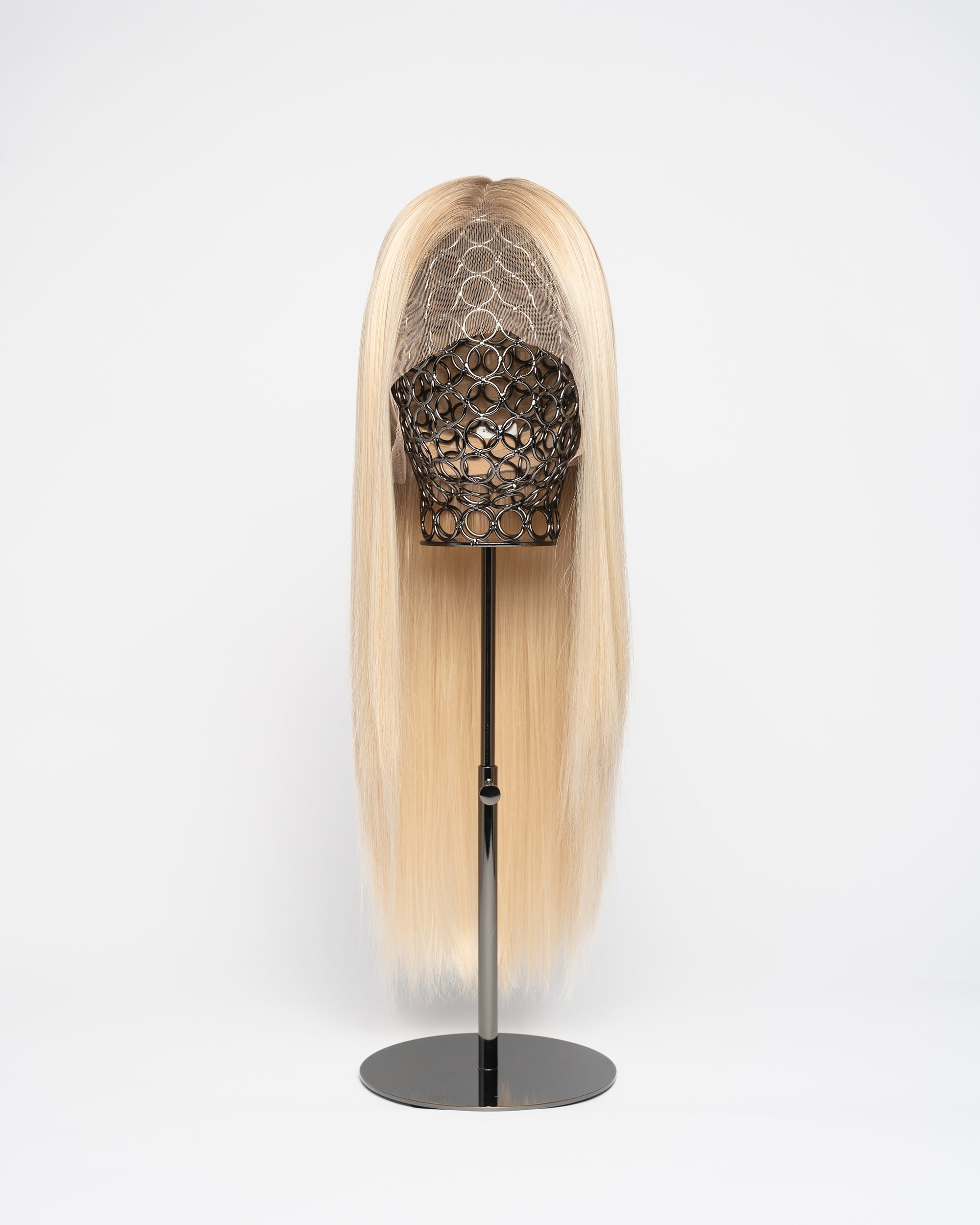Aspen - Scandinavian Blonde synthetic wig on a stand against a white background