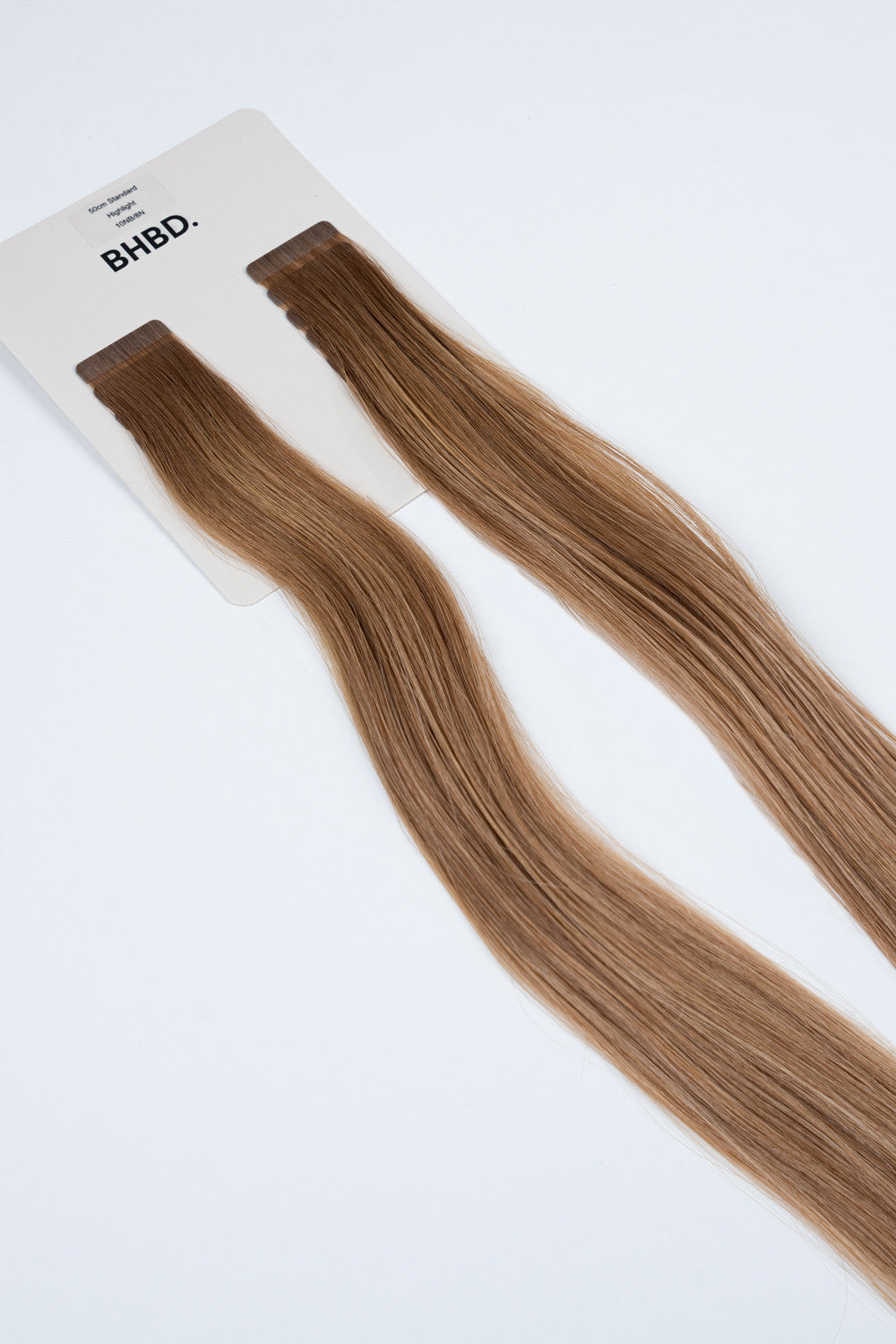 BHBD Tape Extensions 10NB/8N Highlight – pre-taped Remy human hair extensions in light brown and blonde highlights; seamless, soft and tangle-free; comes in 35cm, 50cm, and 60cm. 100% Remy hair, gentle extensions.