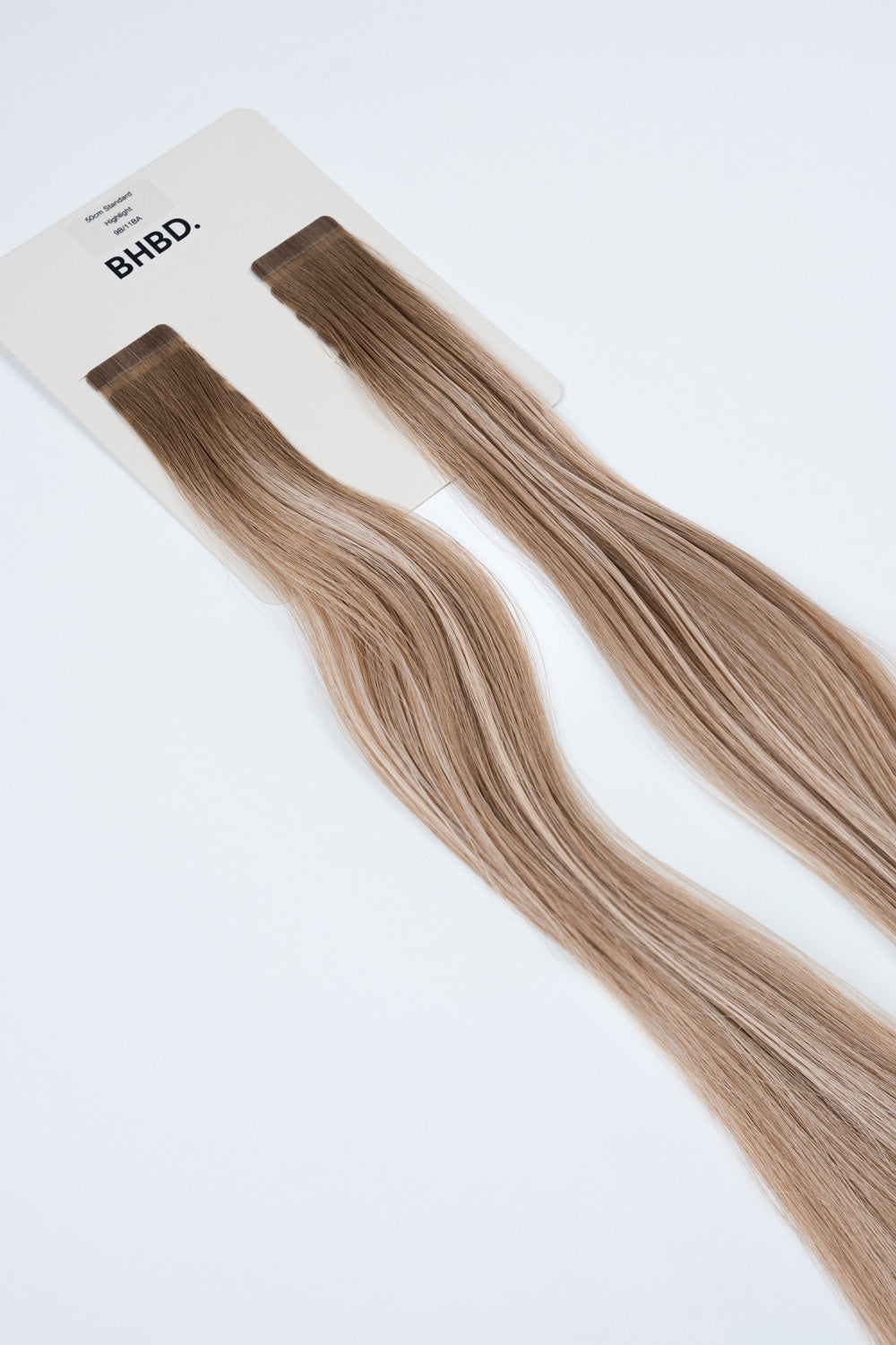 BHBD Tape Extensions 9B/11BA Highlight – pre-taped Remy human hair extensions in ash blonde and beige highlights; seamless, soft and tangle-free; comes in 35cm, 50cm, and 60cm. 100% Remy hair, gentle extensions.