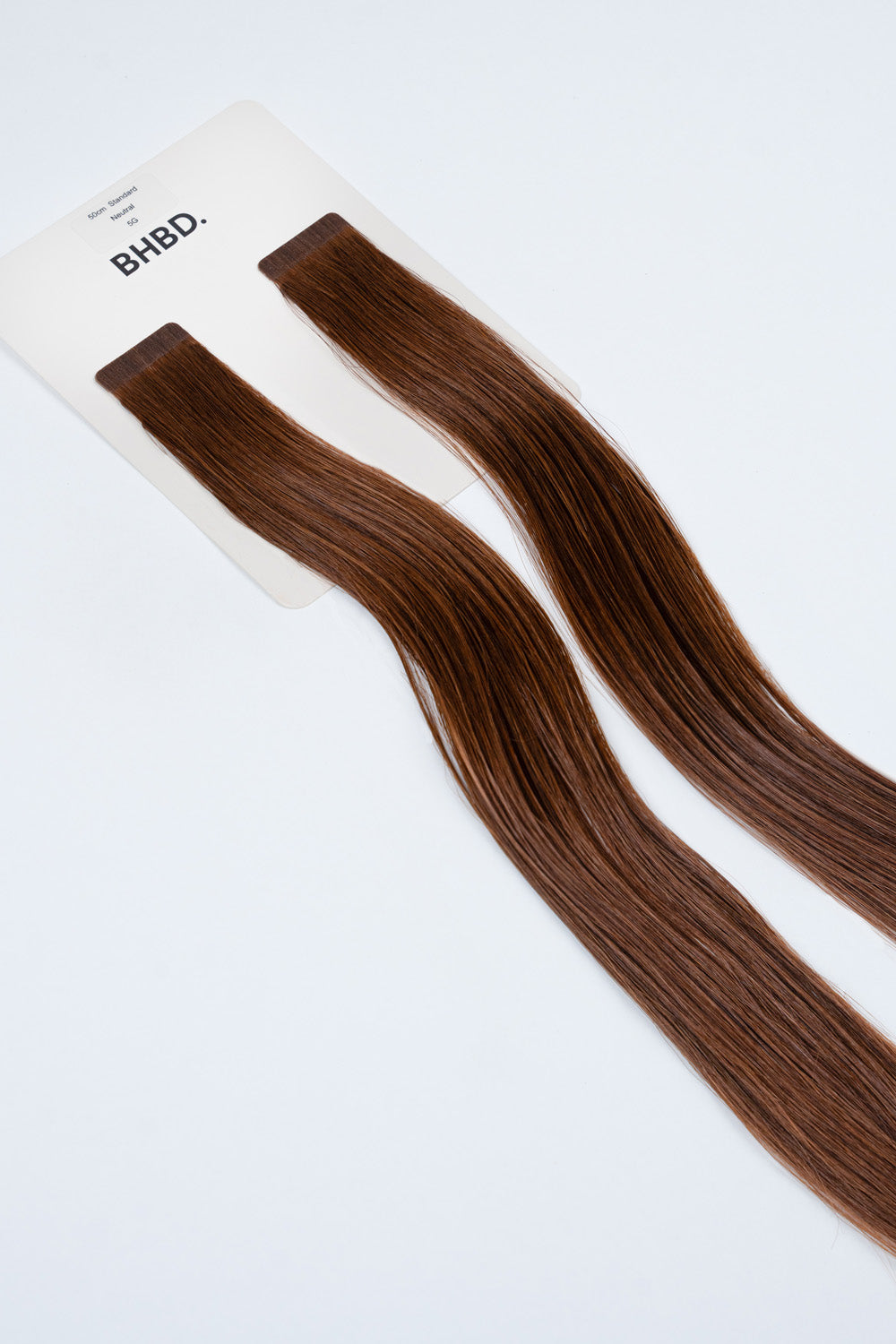 BHBD Tape Extensions 5G – pre-taped Remy human hair extensions in golden brown shade; seamless, soft and tangle-free; comes in 35cm, 50cm, and 60cm. 100% Remy hair, gentle extensions.
