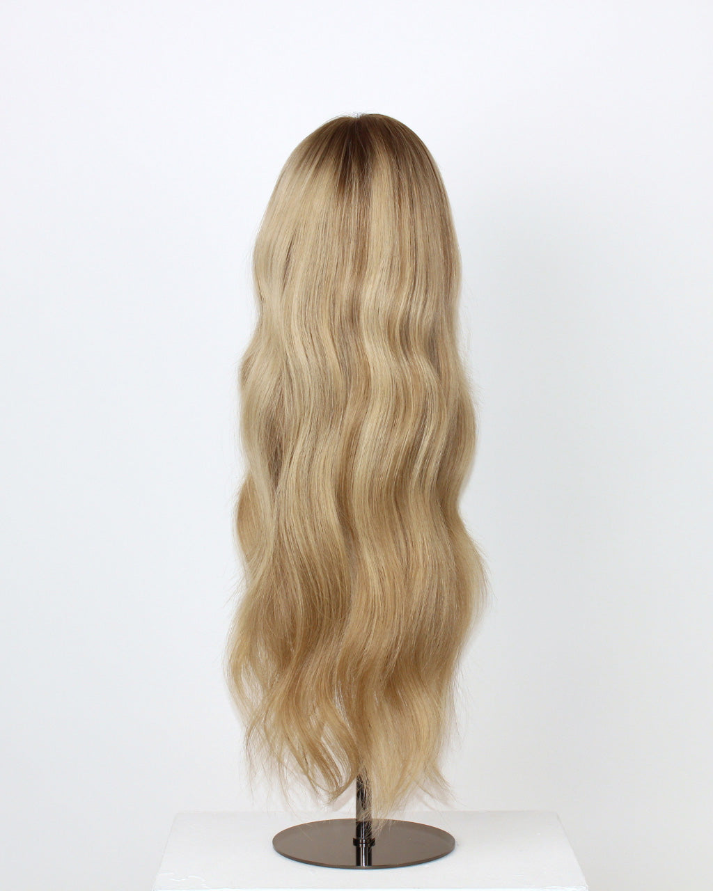Scarlet Wig 50 cm blonde Remy human hair wig with soft lowlights and darker root for depth and texture, displayed on stand.