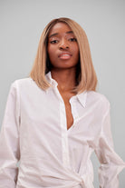 Woman wearing a BHBD Serena wig. Natural brown wig with darker roots and lighter brown lengths.