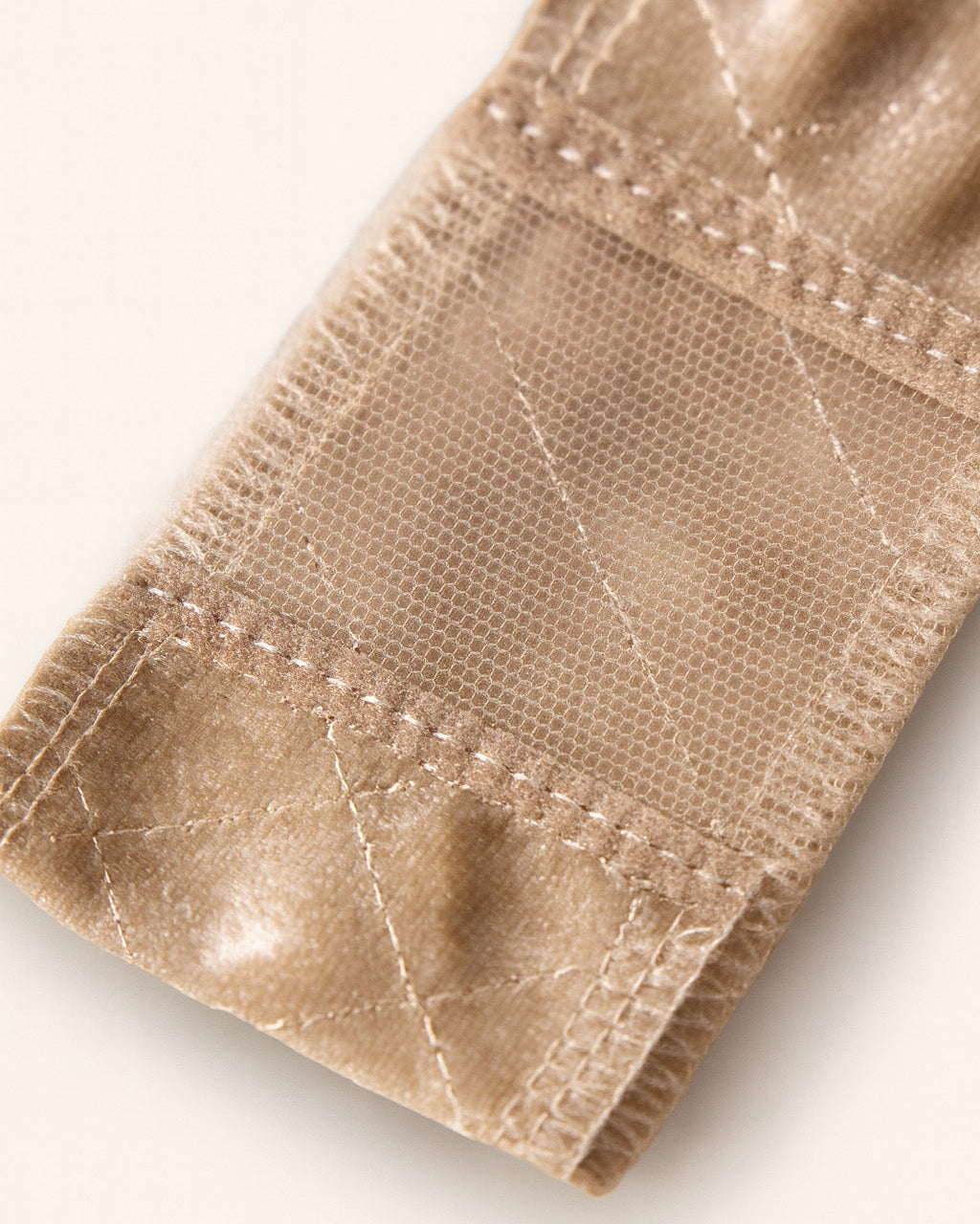 Close up on lace part of a beige velvet wig grip